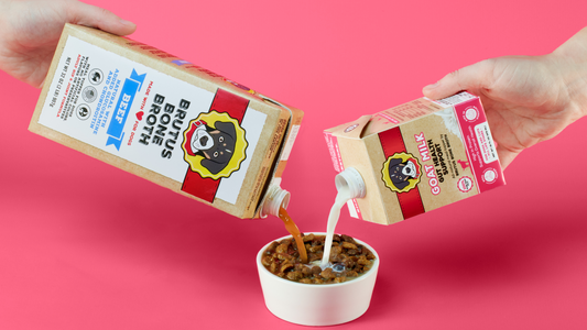 Brutus Broth and Goat Milk being poured over a bowl of kibble