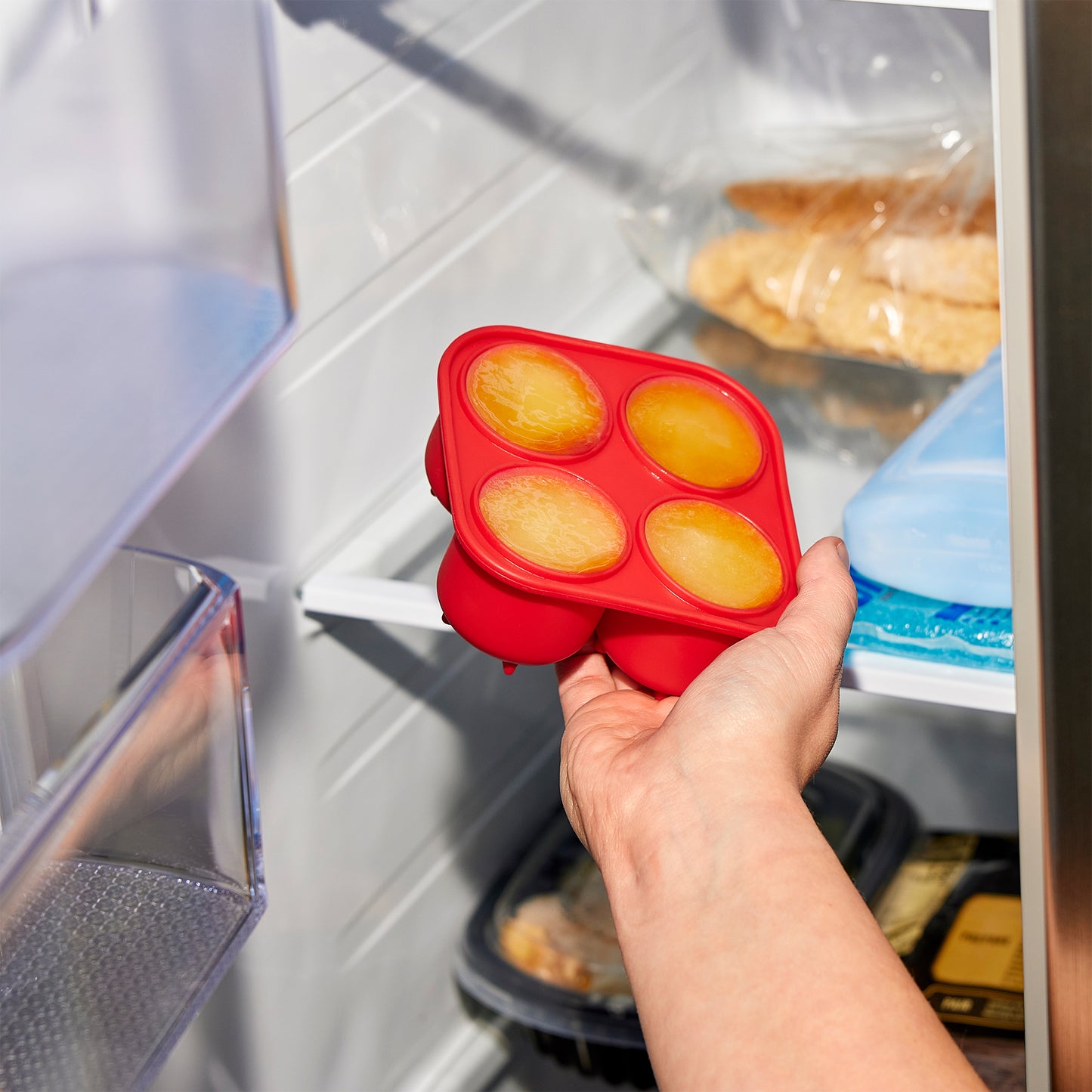 Hand pulling the frozen ice mold out