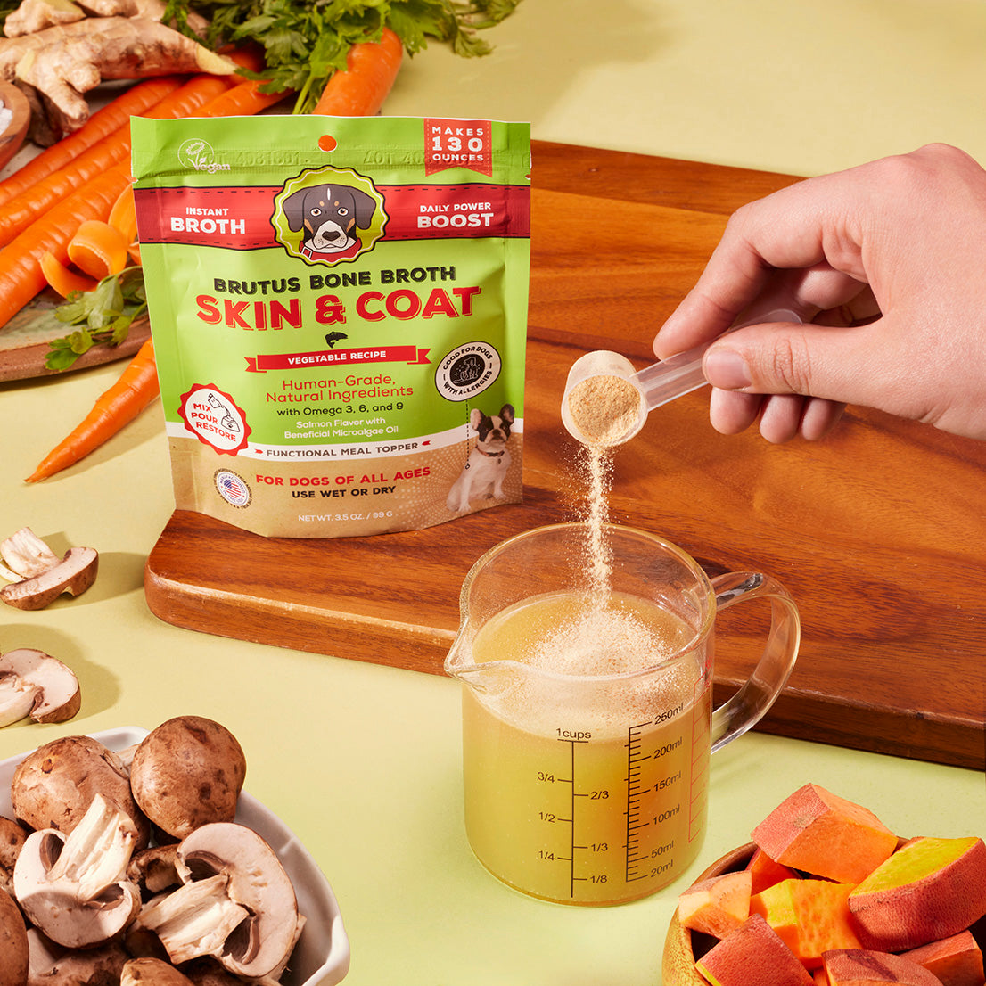 Pouring Brutus Bone Broth Skin & Coat Vegetable Bone Broth Powder into 8 ounces of water