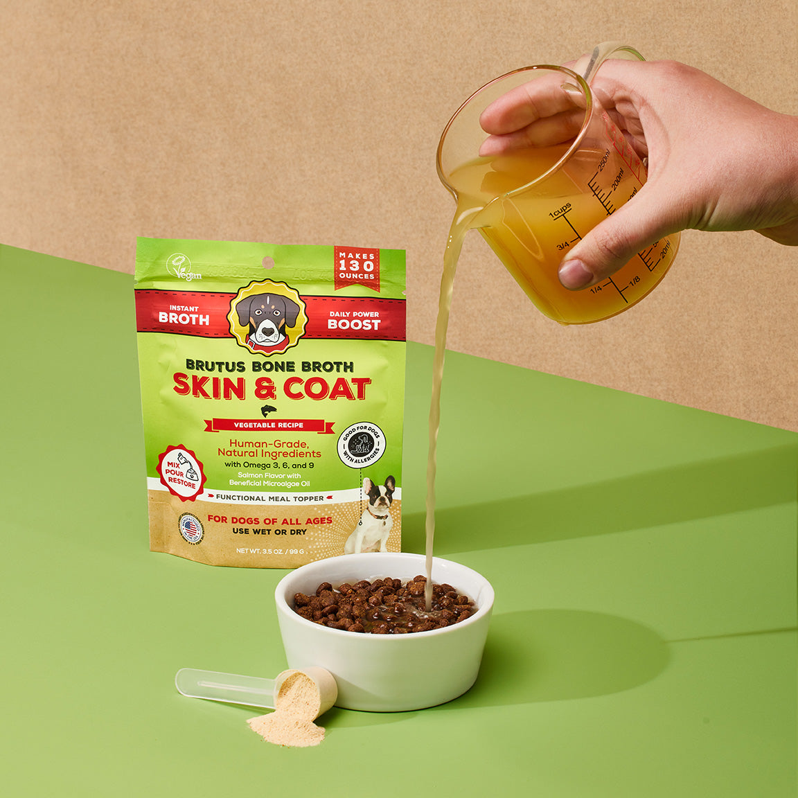 Pouring Brutus Bone Broth Skin & Coat Vegetable Bone Broth Powder on kibble