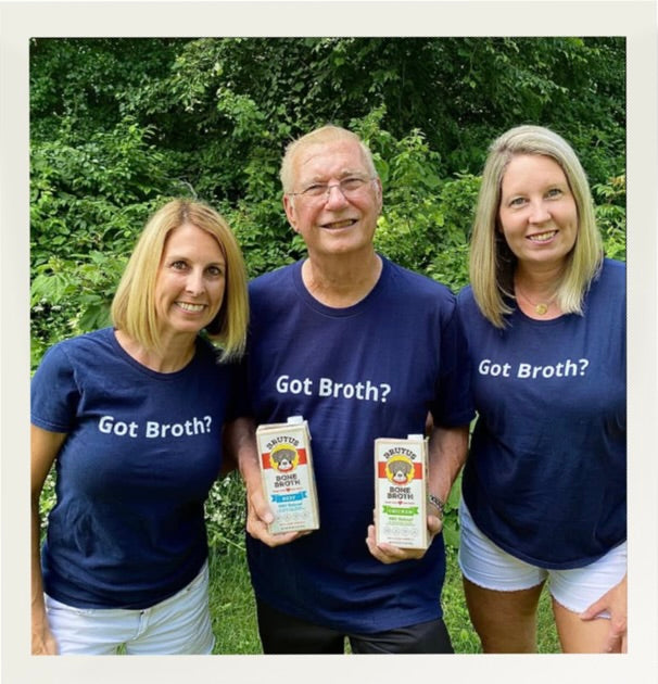 Kim Hehir, Tom Moffitt, and Sue Delegan holding 2 boxes of Brutus Broth