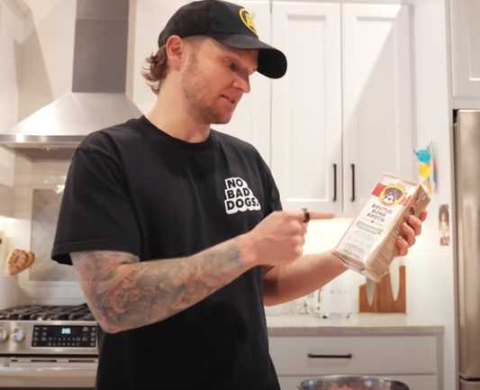 Tom Davis pointing at Brutus Bone Broth