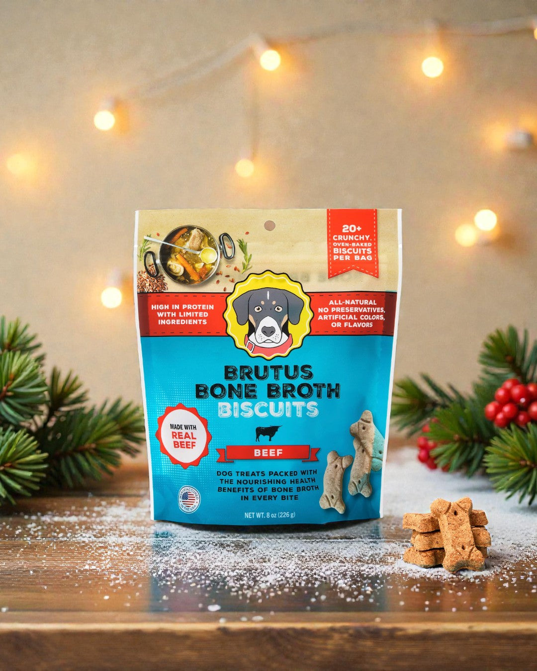 Brutus Bone Broth Biscuits package on a wooden surface with decorative lights and greenery.