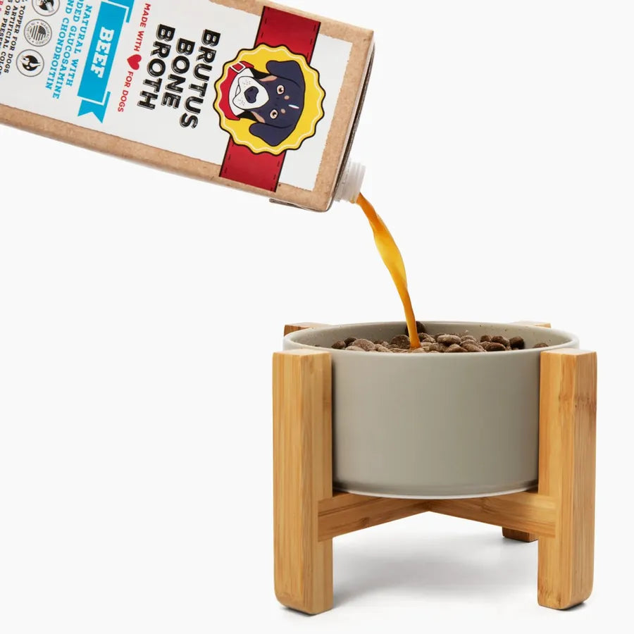 Brutus Bone Broth pouring into a bowl on a wooden stand