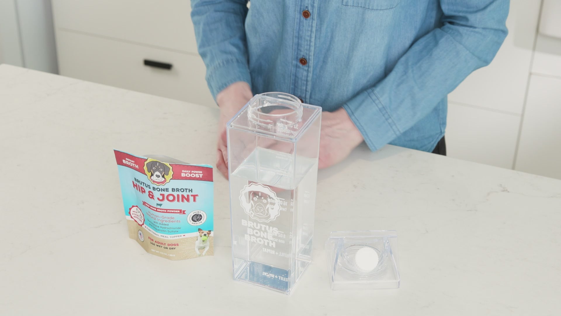 A man scoops Brutus Bone Broth Hip & Joint Mega Pack and pours it into the Brutus Shaker cup.